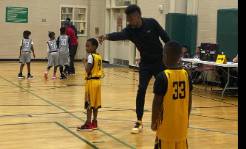 dedicated basketball student, intense focus, analyzing playbook strategy, photorealistic, library setting with basketball memorabilia, highly detailed, pages flipping, fine textures, calm colors, soft table lamp lighting, shot with a 85mm lens